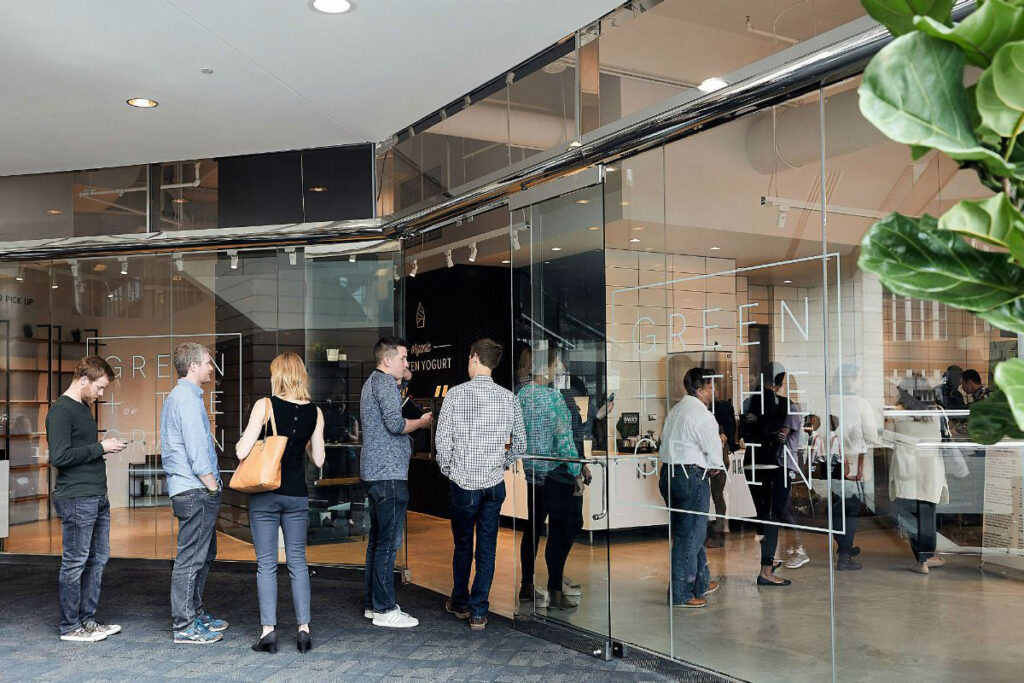 Customers in a line outside the door for Green + the Grain